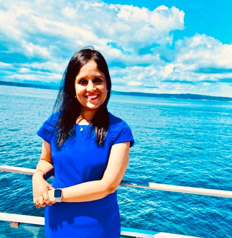 Gunjan Sinha smiling on a boat by the sea